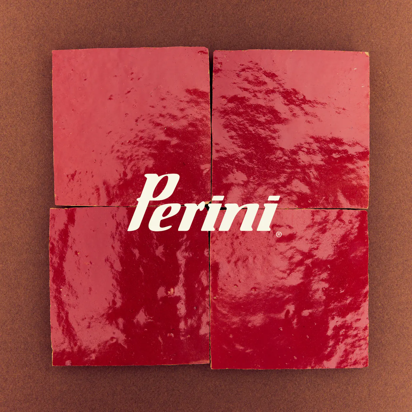 Perini logo on four glossy red tiles