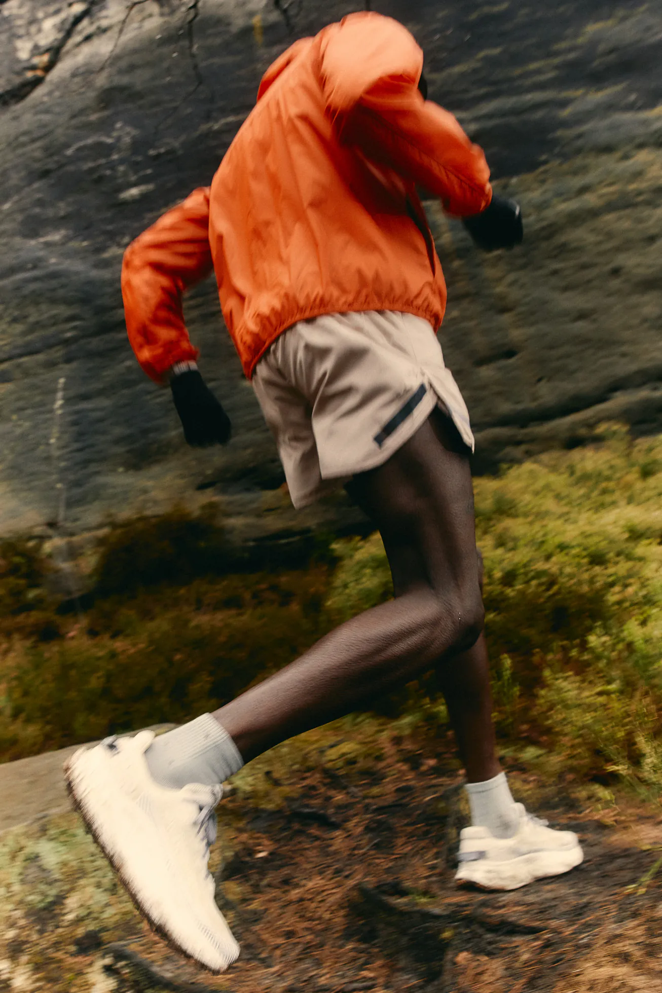 Runner in white trainers on a rocky trail