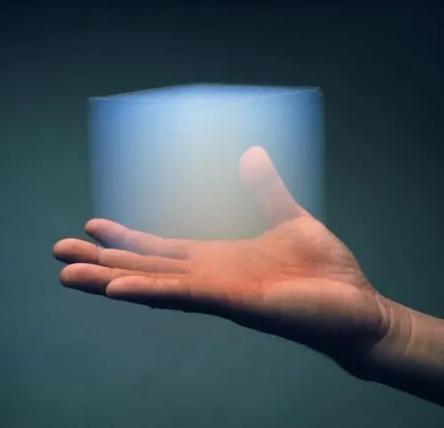 Open hand beneath a glowing translucent cube