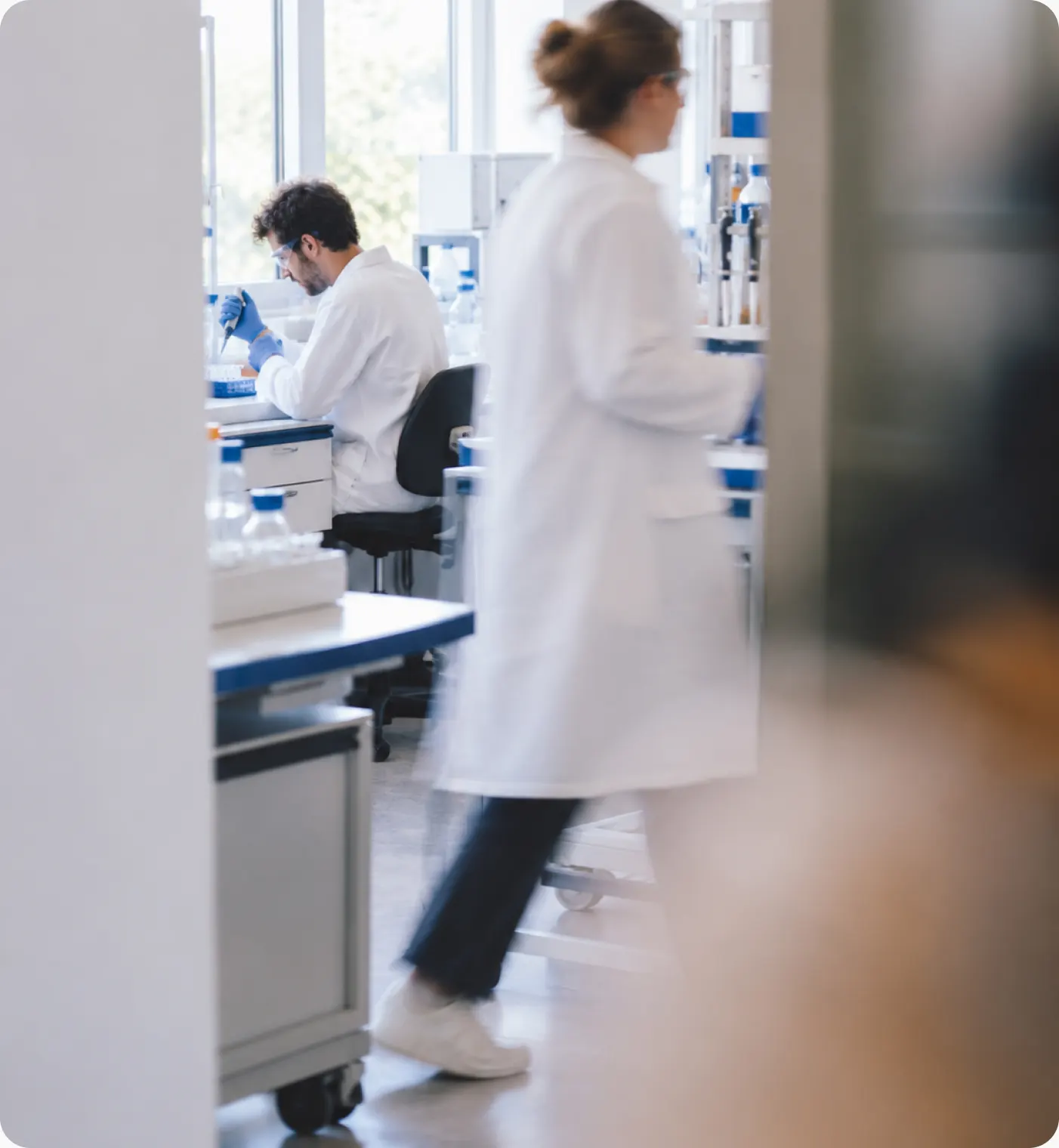 Scientists at work along a laboratory corridor